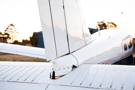 Private twin engine aeroplane on rural landing strip at dusk