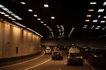 Cars travelling through city toll road underground tunnel in Sydney
