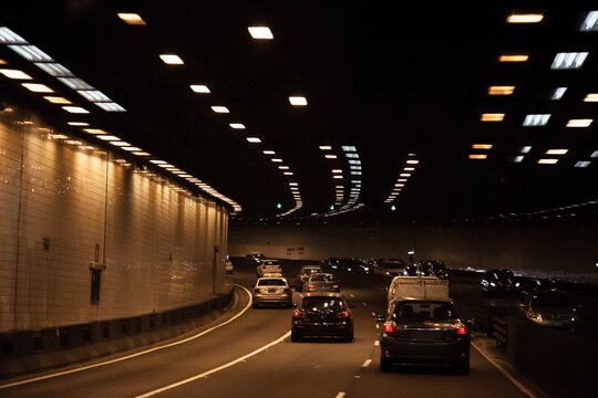 Cars travelling through city toll road underground tunnel in Sydney
