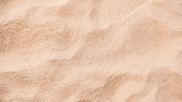 Background image of fine sand at the beach for adding desired text.