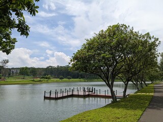 Mini jogging park on the Semarang Central Java with lake, cloudy vibes and blue sky. The photo is...