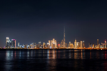 view of Dubai Downtown cityline from Dubai Creek Canal at night