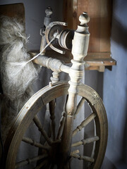 Ancient wooden spinning wheel, spindle. Traditional vintage equipment for making thread and fabric