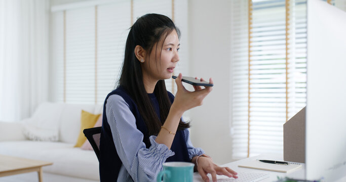 Asia people young casual woman remote work at desk home mobile phone call voice chat talk study learn MBA online class. SEO sale plan report on desktop PC reskill upskill career job smart workforce.