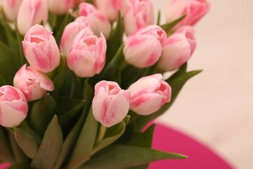 Obraz premium Beautiful bouquet of fresh pink tulips on blurred background, closeup