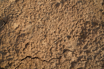 Yellow sand textured background. The texture of the sand in the cracks, photo. Natural, rough, hard...