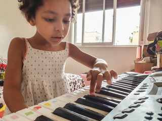 Home Music Lesson: Cute Multicultural Girl's Piano Practice. Copy space.