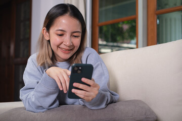 Close-up shot of an woman hand using her smartphone, chatting with someone or scrolling on her phone while relaxing. online communication technology concept.