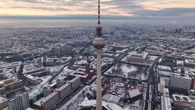 City of Berlin, Germany from above. Aerial winter cityscape view at sunrise or sunset, showing architectural landmarks Oberbaum Bridge, TV Tower and Berlin Cathedral in winter. 