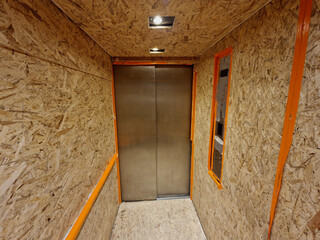 office equipment via a personal elevator must be sealed and covered with boards to protect the stainless steel interior of the luxury elevator. construction work and reconstruction © Michal