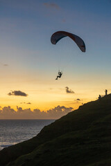 paraglider silhouette at sunset