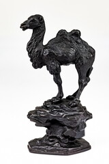 A purchased (consumer) figurine of camels made of cast iron in close-up on a white background