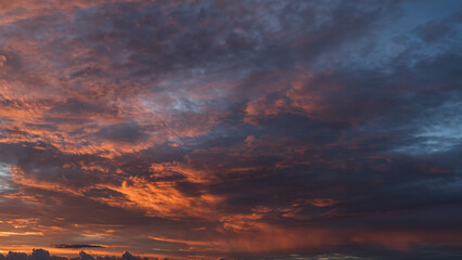 Dramatic sunset with vibrant clouds lit by a sun