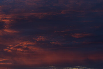 Dramatic sunset with vibrant clouds lit by a sun