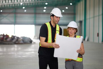 workers or engineers planning from work on blueprint drawing paper in the factory