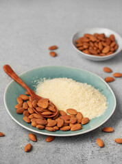 Fresh almond flour in a  bowl and almonds