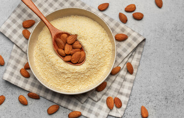 Fresh almond flour in a  bowl and almonds