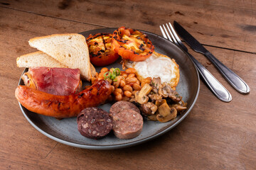 breakfast dish English Irish UK with lots of protein sweet beans sausage bacon egg mushrooms black...