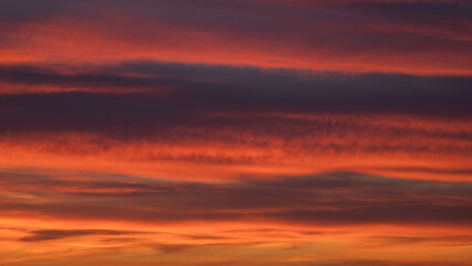 Dramatic sunset with vibrant clouds lit by a sun