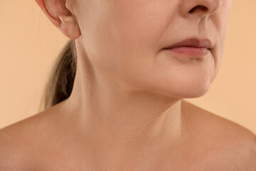 Woman with normal skin on beige background, macro view
