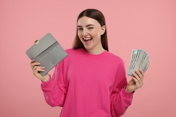 Happy woman with wallet and dollar banknotes on pink background - obrazy, fototapety, plakaty