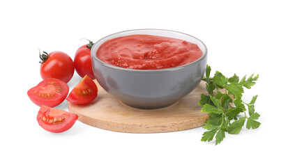 Organic ketchup in bowl, fresh tomatoes and parsley isolated on white. Tomato sauce