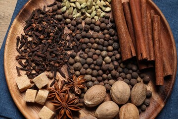 Different spices and nuts on table, top view