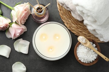 Flat lay composition with different spa products and rose flowers on grey table