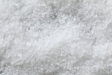 White natural salt as background, top view