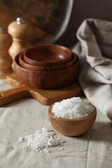 Organic salt in wooden bowl on table
