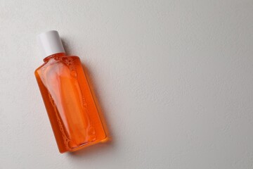 Fresh mouthwash in bottle on white background, top view. Space for text