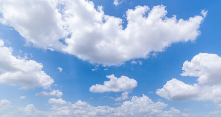 Panoramic view of clear blue sky and clouds, Blue sky background with tiny clouds. White fluffy clouds in the blue sky. Captivating stock photo featuring the mesmerizing beauty of the sky and clouds.