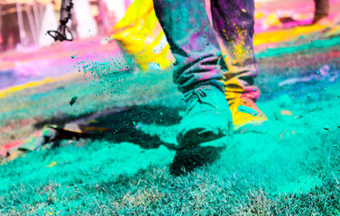 Shoes of a person covered in powder paint- celebrating Holi Festival of colors at La Tomatina...