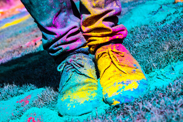 Shoes of a person covered in powder paint- celebrating Holi- Festival of colors at La Tomatina...