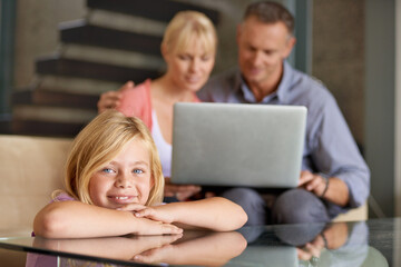 Portrait, happy child and parents in lounge with love, relax and laptop for movie on weekend in...