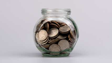 Saving coins in a glass jar, savings concept, financial planning and investment Cash flow and income