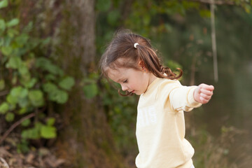 Adorable little girl playing in the park on a sunny day.