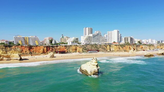 The city of Albufeira on the edge of the cliffs and the Ocean , in Europe, in Portugal, in the Algarve, in summer, on a sunny day.
