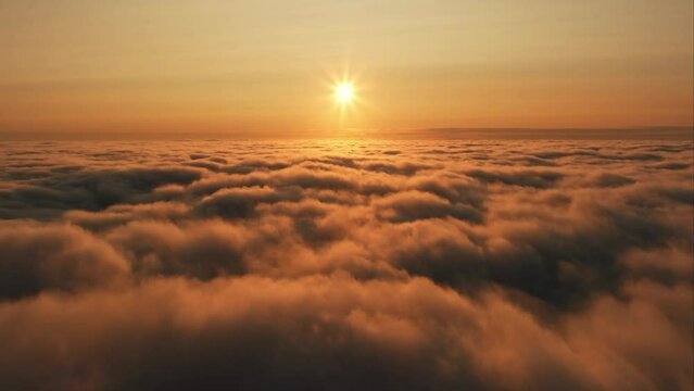 Traveling in the clouds with a drone Sky and sunset sun rays reflected on the clouds like gold Slow motion
