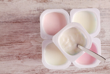 Assorted yogurt in plastic cups