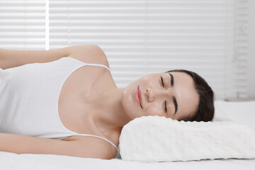 Obraz na płótnie Canvas Woman sleeping on orthopedic pillow at home