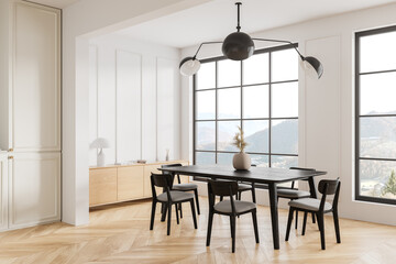 Light living room interior with eating table and chairs, panoramic window