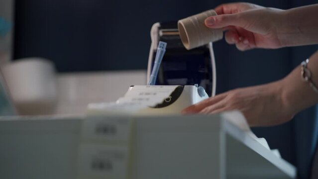 woman uses thermal shipping barcode label printer to print labels