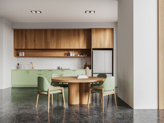 White and green kitchen interior with dining table