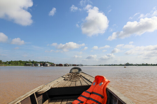 seascape with bow of wooden boat and life jacket on mekong river