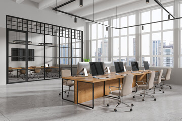 Stylish workplace interior with armchairs and pc computers, panoramic window