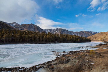 Russia, Gorny Altai. The frozen Katun River, mountains and taiga along the river bank - 744512065