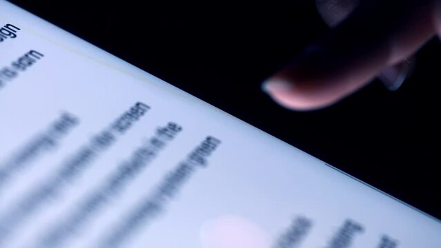 Background of extremely close-up  human fingers scrolling touching the tablet screen. Social media communication.