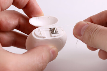 Unwind and tear off a section of dental floss. Dental care.