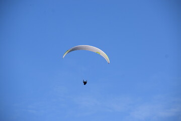 paraglider in blue sky